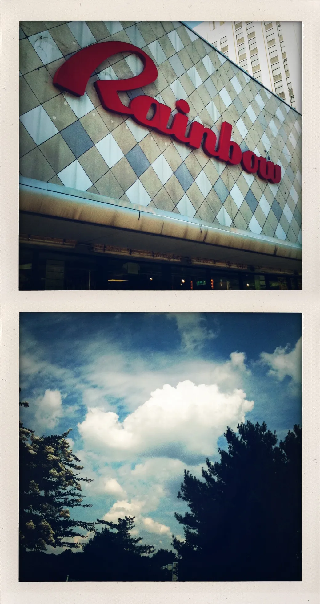 Red “Rainbow” sign on a tiled building above; below, a cloud-filled sky with silhouetted trees at the bottom of the frame.