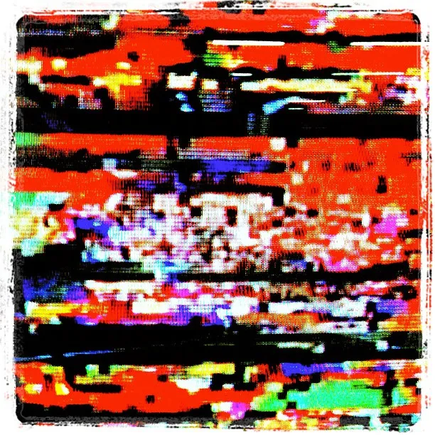 Close-up of a distorted TV screen displaying vibrant digital noise and glitch patterns in red, black, purple, green, and white.