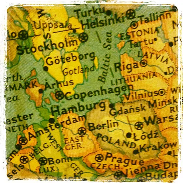Close-up of a colorful printed map showing parts of Northern and Central Europe, including cities like Berlin, Riga, and Warsaw.