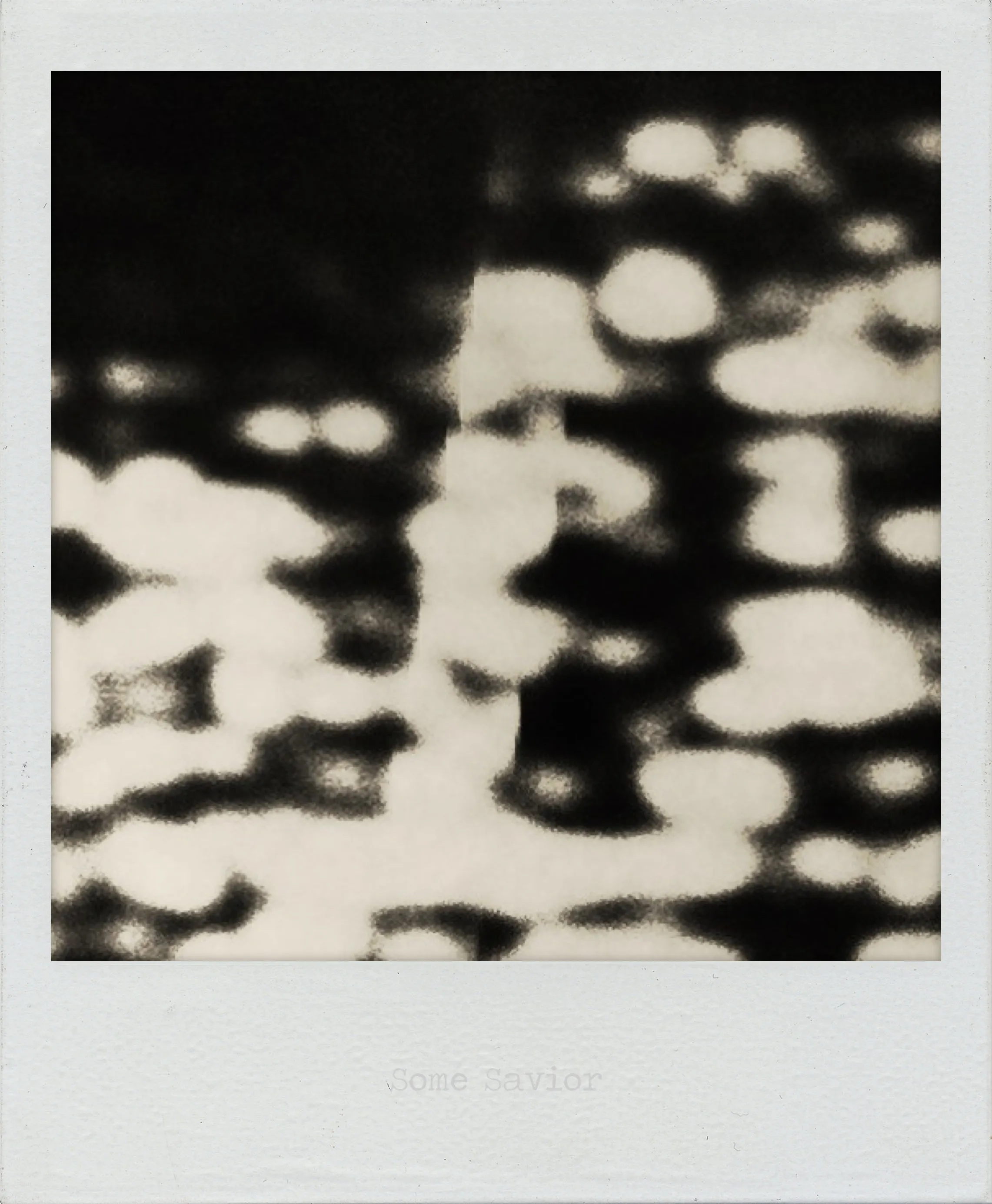 Abstract black and white image with irregular soft-edged white shapes dispersed across a dark background.