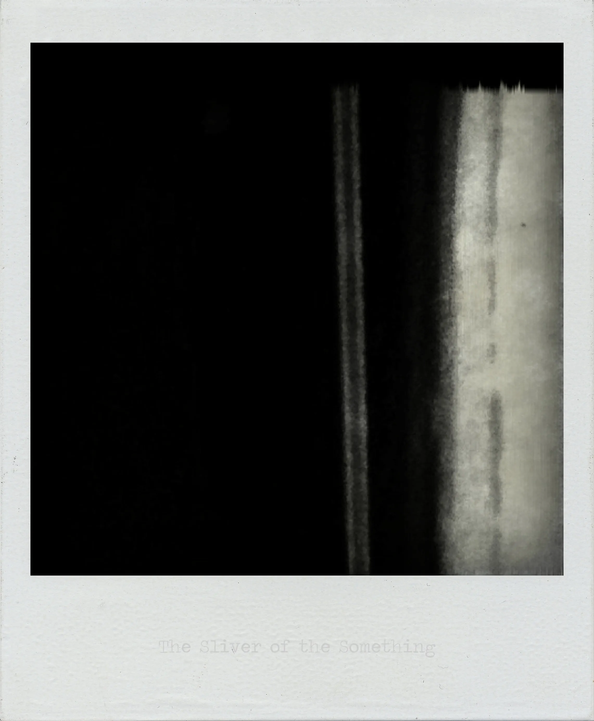 Dark abstract image with a vertical pale strip on the right, bordered by blurry light and dark tonal gradients.