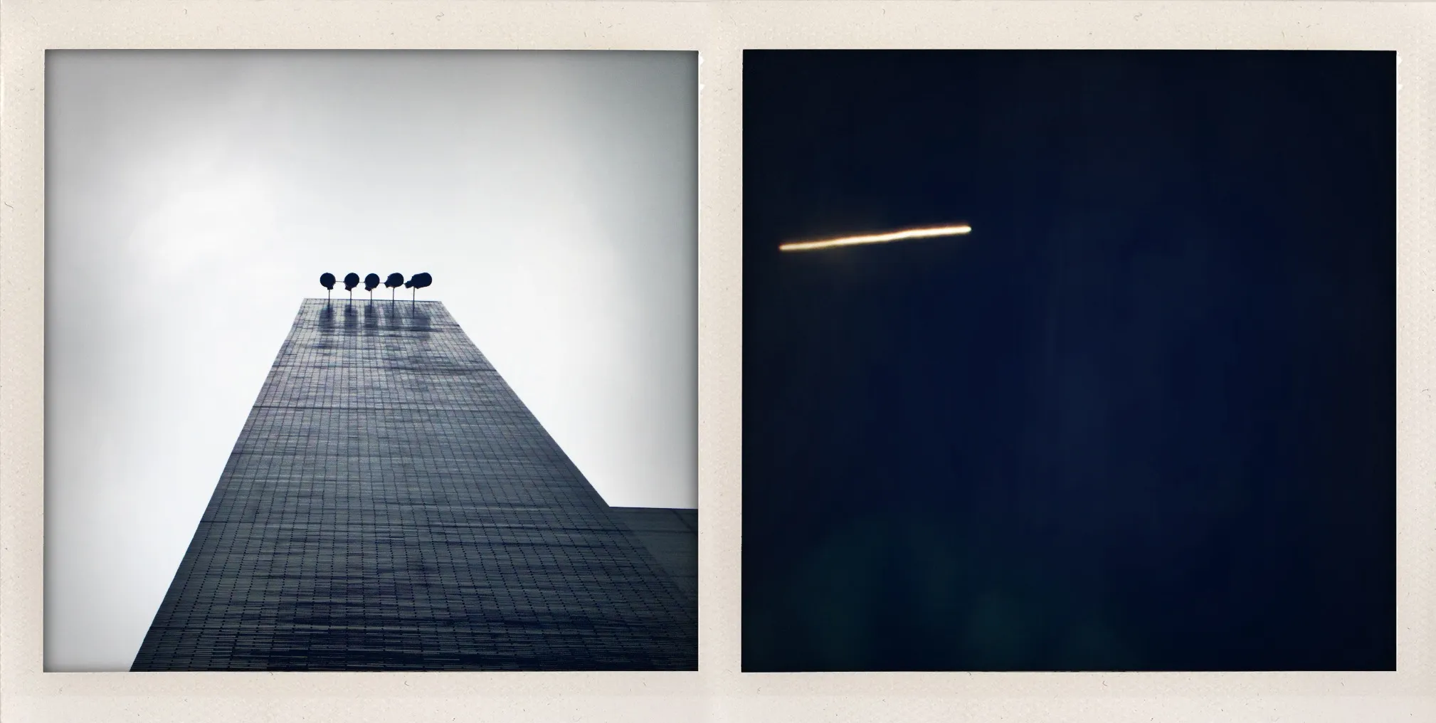 Five lit circular bulbs on a tall building next to a diagonal streak of white light on a dark blue background.