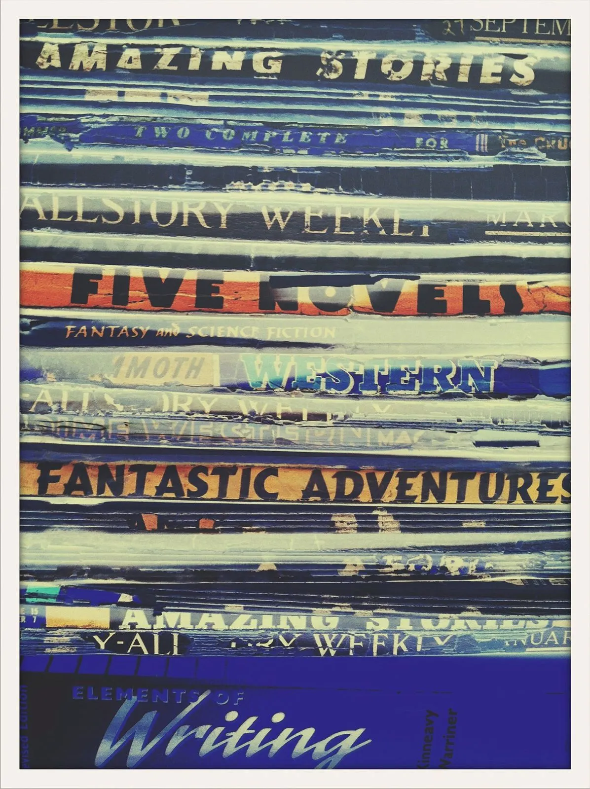 Stack of colorful, worn magazine spines with visible titles like “Amazing Stories” and “Fantastic Adventures.”